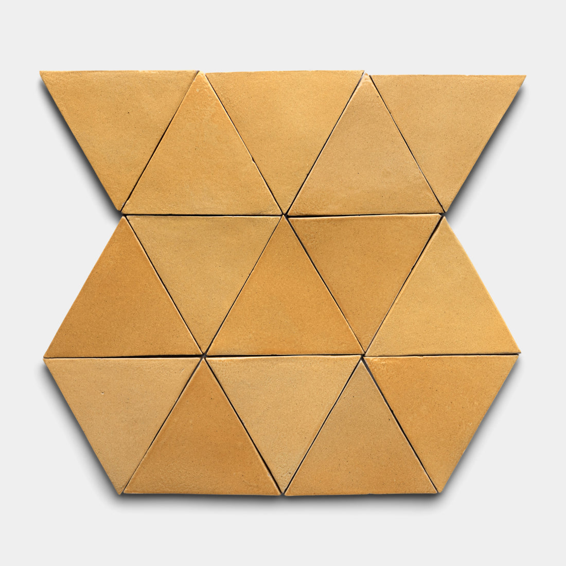Twelve Dorado Triangle tiles by Zia Tile, in brown, are arranged in a geometric hexagon with two triangles missing from the top and bottom, set against a light gray background.