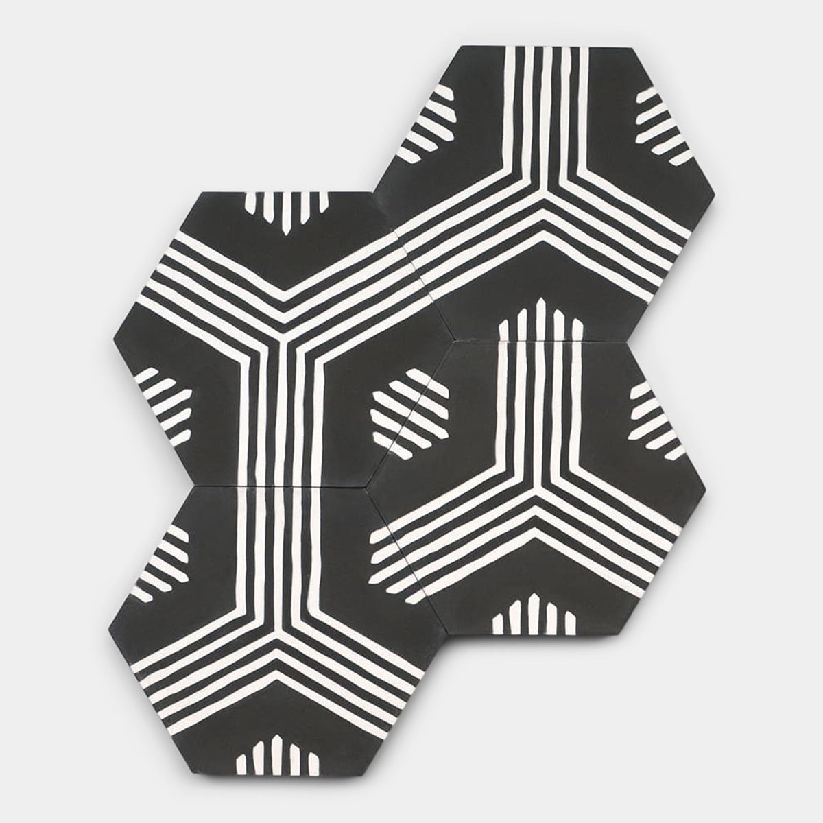 Three Echo Charcoal Hex tiles by vendor-unknown are arranged together, each showcasing bold white lines that form geometric patterns aligning across the black hex tiles for a continuous, modern look.