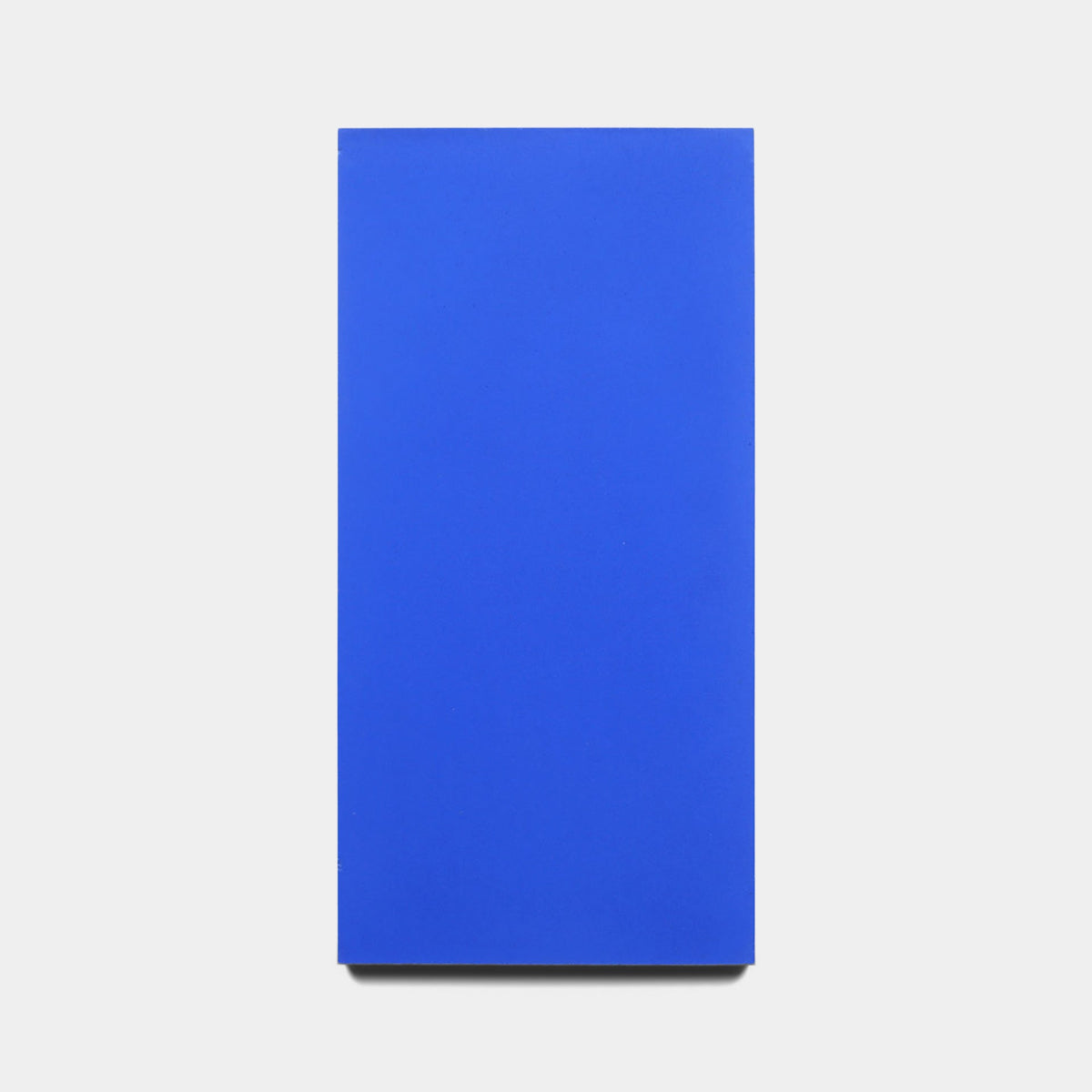A rectangular, vertical canvas painted in Elemental Blue mimics the Zia Tile Elemental Blue 4x8 Sample and is shown against a plain white background.