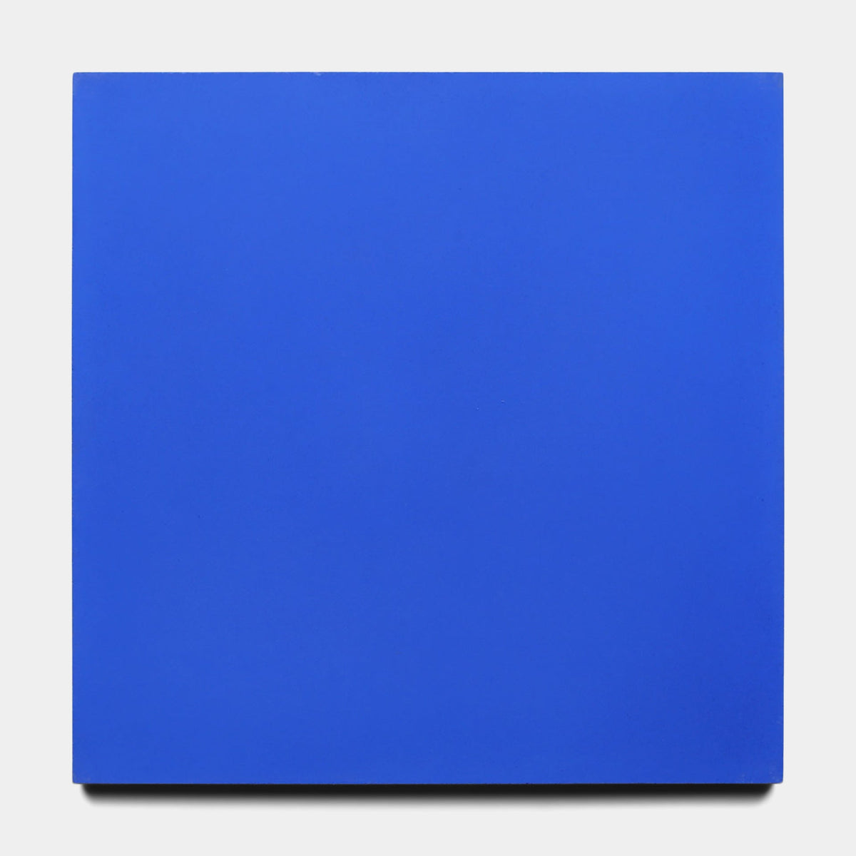 The Zia Tile Elemental Blue 8x8 Sample is a square tile painted in vibrant blue, displayed on a plain white background.