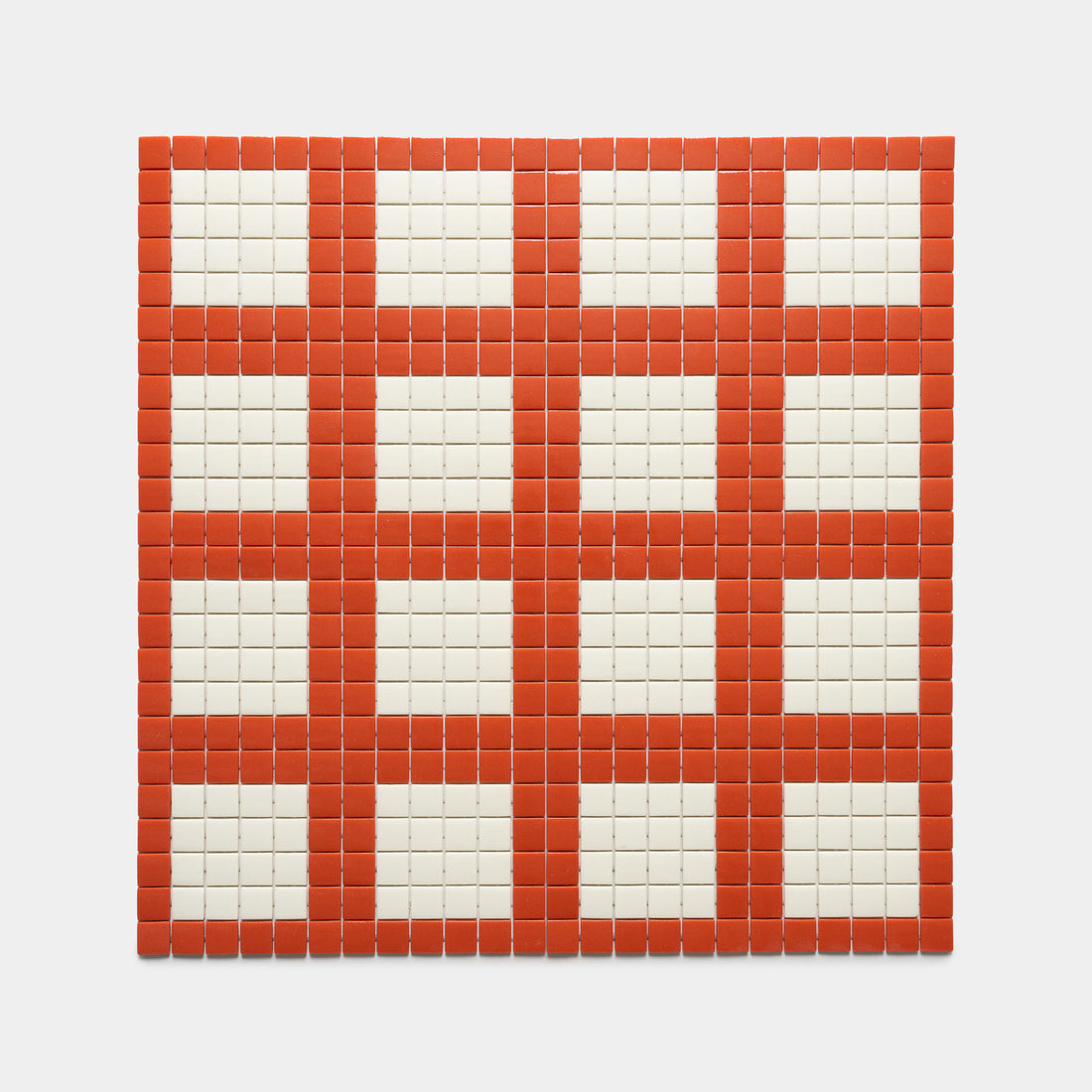 The Ells Roma + Milk tile by Zia Tile features a square grid of small tiles with red borders, forming a five-by-five checkerboard pattern with white centers and red edges on a plain white background.