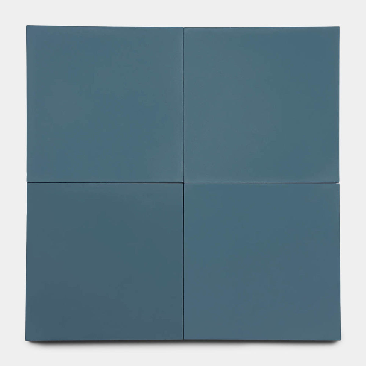 Four matte Zia Tile Elemental Blue 8x8 sample tiles, arranged two-by-two on a white background, form a sleek square with clean lines—ideal for showcasing modern style.