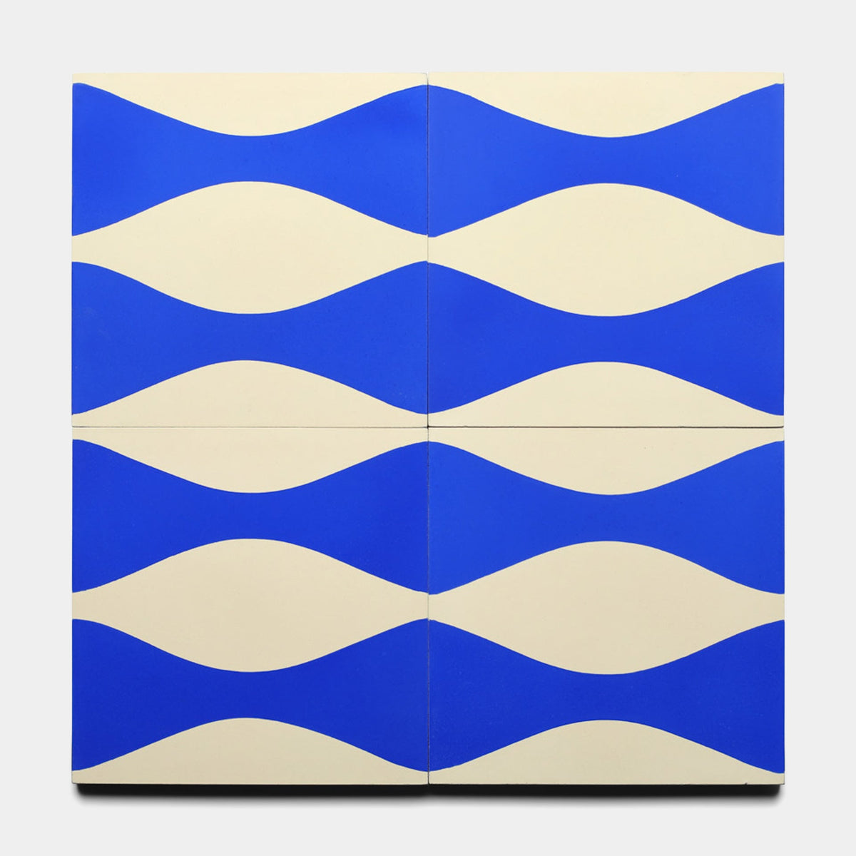 Four Enzo Elemental Blue 8x8 samples from Zia Tile, arranged in a grid, display horizontal blue waves on a white background for a dynamic, wavy look.