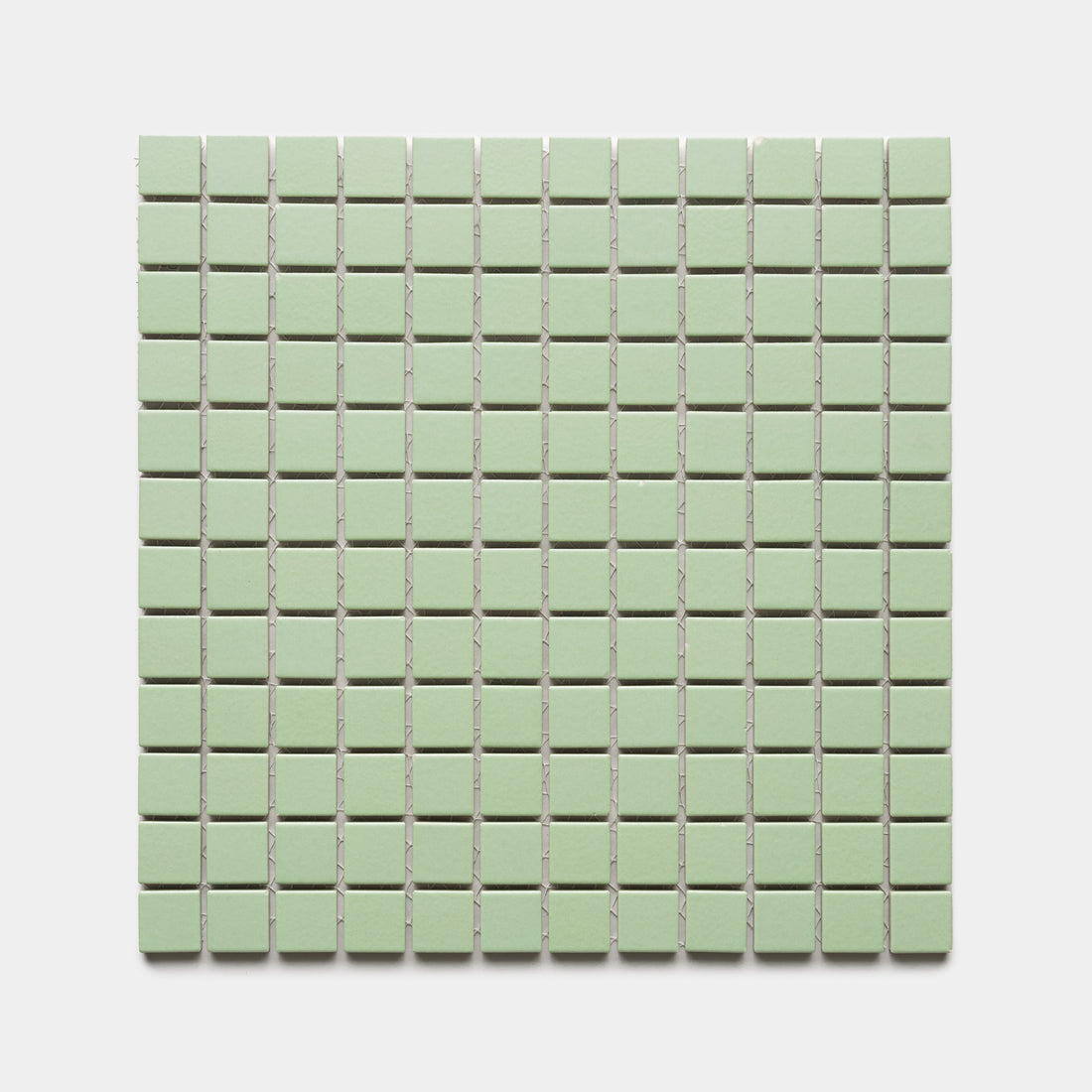 Eucalyptus 1x1 by Zia Tile features small, square, light green tiles arranged in an even grid across a white background.
