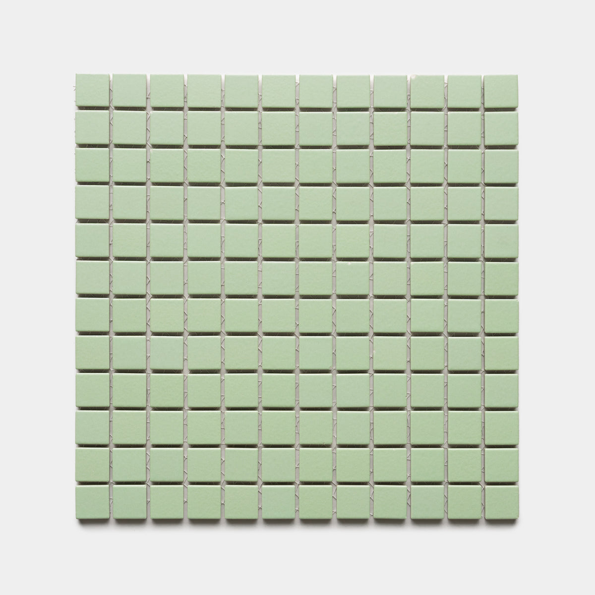 Eucalyptus 1x1 by Zia Tile features small, square, light green tiles arranged in an even grid across a white background.