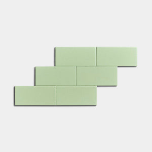 Six Eucalyptus 2x4 ceramic tiles by Zia Tile, in a pale green matte finish, are arranged in a staggered brick pattern against a plain white background.