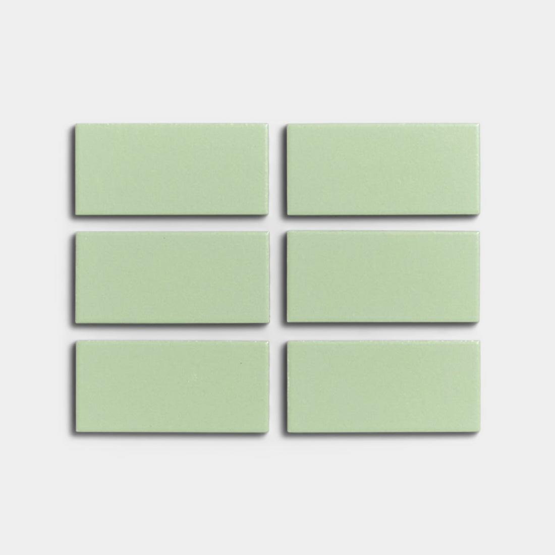 Six Eucalyptus 2x4 mint green matte ceramic tiles by Zia Tile are arranged in two rows of three on a plain white background, ideal for indoor or outdoor installations.