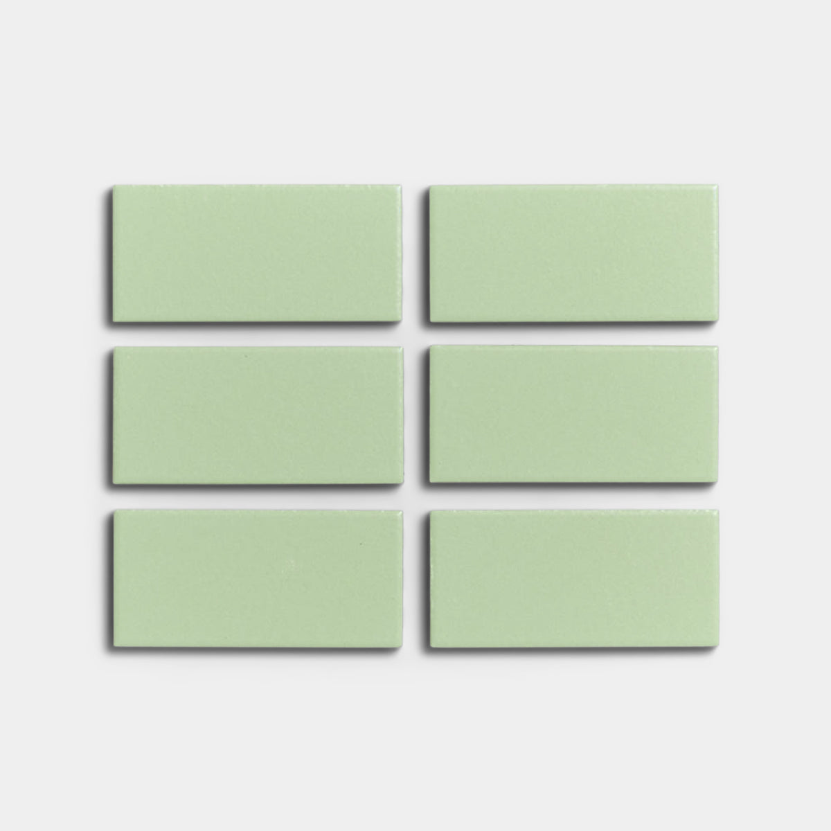 Six Eucalyptus 2x4 mint green matte ceramic tiles by Zia Tile are arranged in two rows of three on a plain white background, ideal for indoor or outdoor installations.