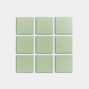 Nine Eucalyptus 4x4 matte ceramic tiles by Zia Tile, in pale green, are arranged in a 3x3 grid on a white background.