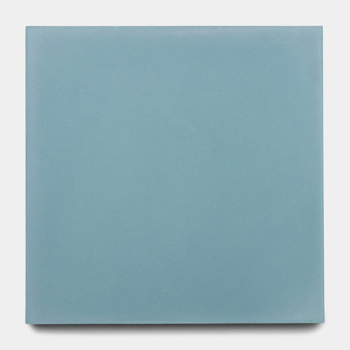 A sample of the Zia Tile Rust 8x8 ceramic tile in a muted light blue, shown as a single plain square against a white background.