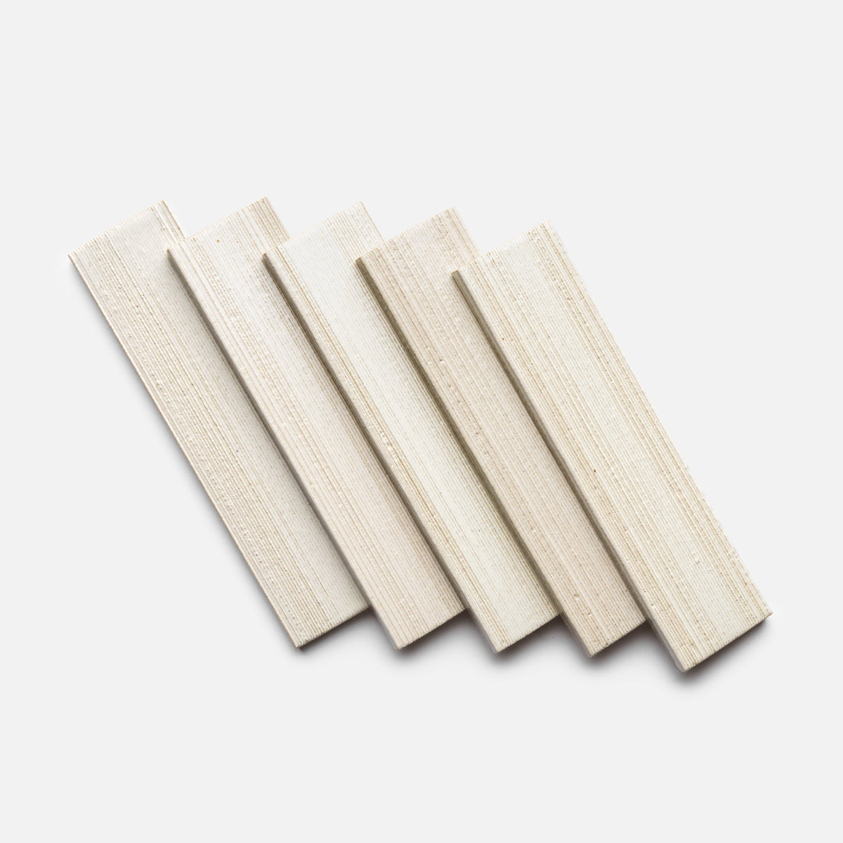 Five Feather + Etched sample boards by Zia Tile are arranged diagonally in a fan shape on a plain white background, showcasing their light color and visible wood grain texture.