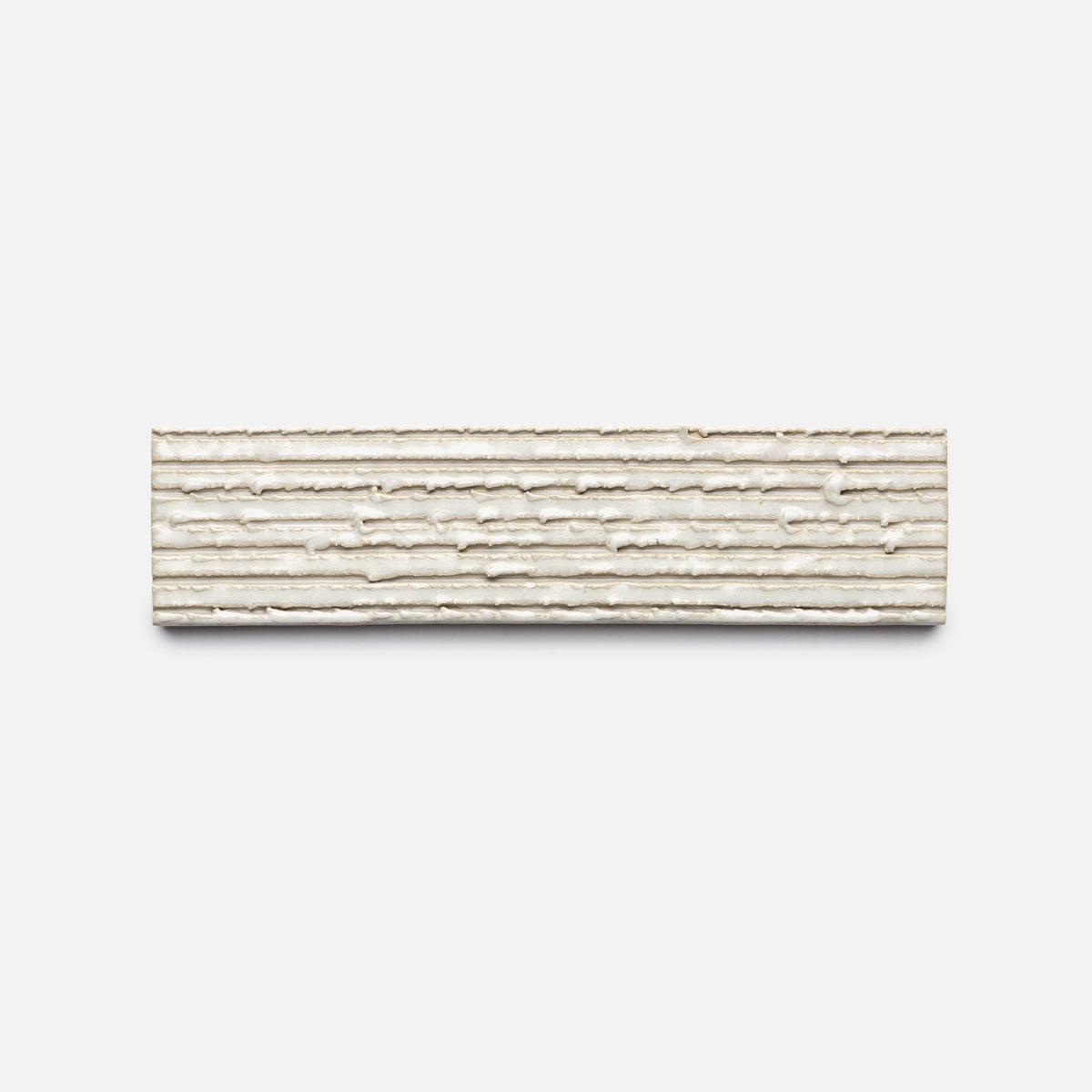 A rectangular, beige Feather + Furrowed, Sample tile by Zia Tile with a textured, lined surface is isolated on a plain white background.