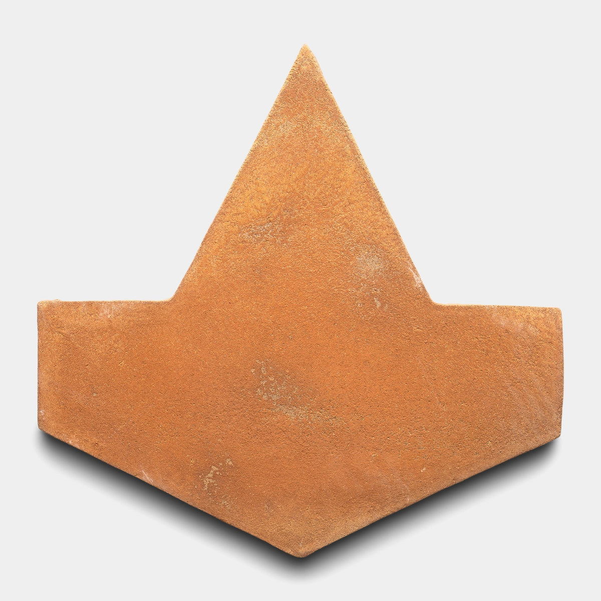 A single Big Alcazar + Fired Earth sample tile by Zia Tile, featuring a chevron shape, textured matte finish, and warm reddish-brown color, displayed on a plain white background.