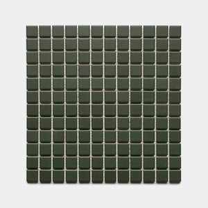 Fraser 1x1 by Zia Tile features small, square dark green tiles with light grout lines, creating a neat and symmetrical pattern on a white background.