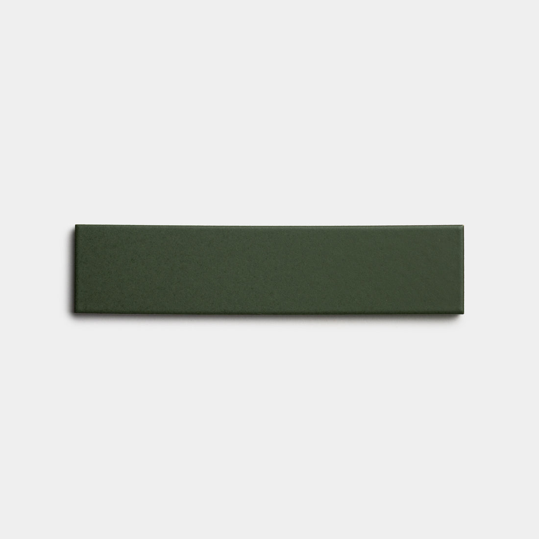 A single Fraser 2x8 rectangular, dark green ceramic tile by Zia Tile displayed on a plain white background.