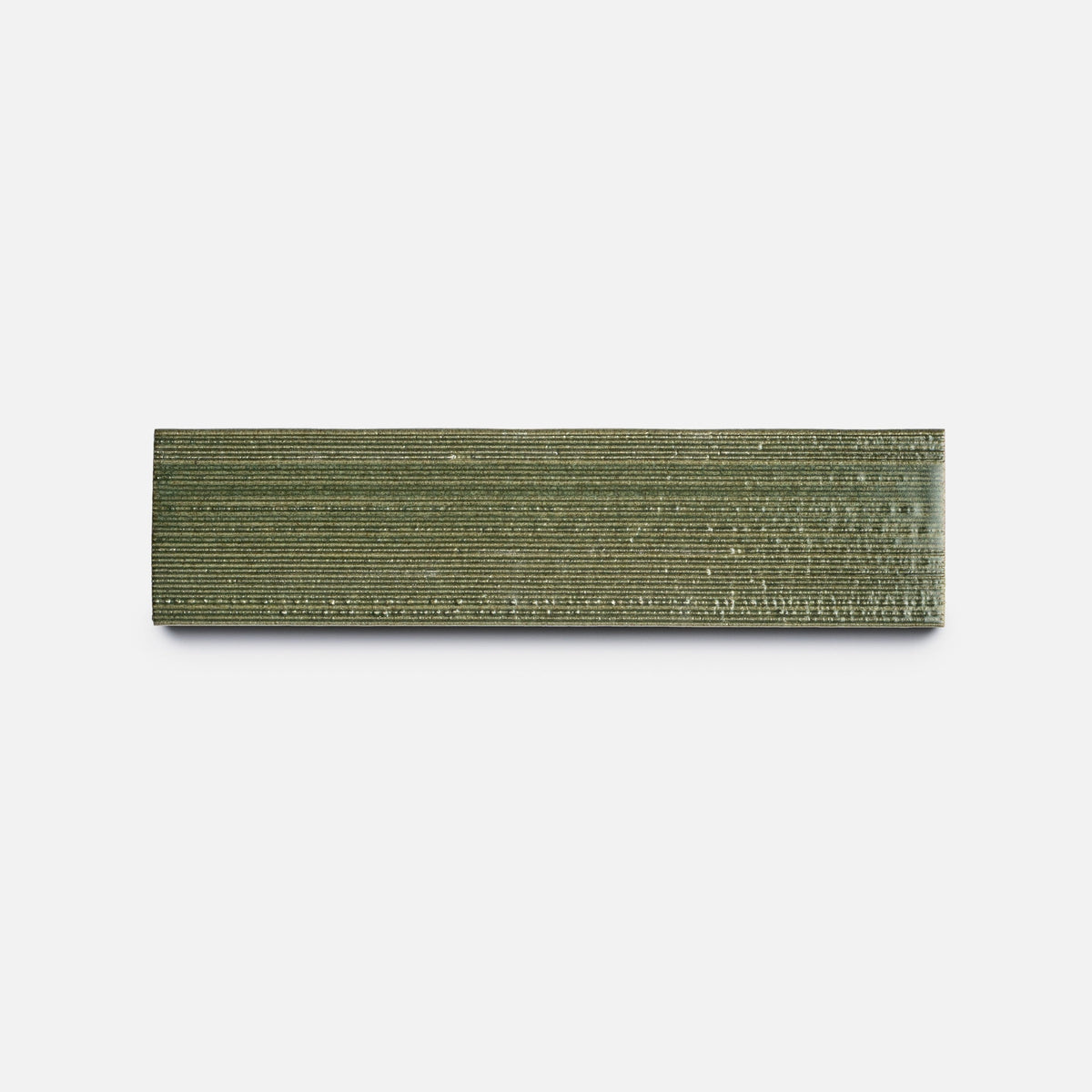 A rectangular, textured bronze bar with horizontal ridges—Zia Tile's Frogtown + Etched (Sample)—is displayed on a plain white background.