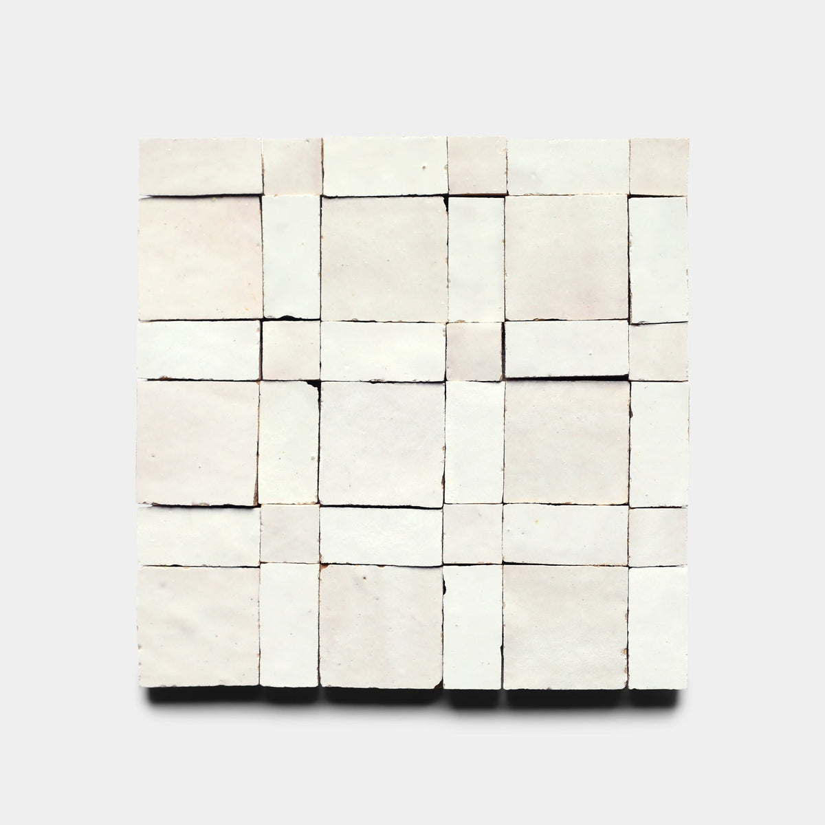 Gambit 1, Sample by Zia Tile is a square art piece featuring 25 handmade tiles in a 5x5 grid, each unevenly cut with visible gaps and varied thicknesses, set against a plain background.