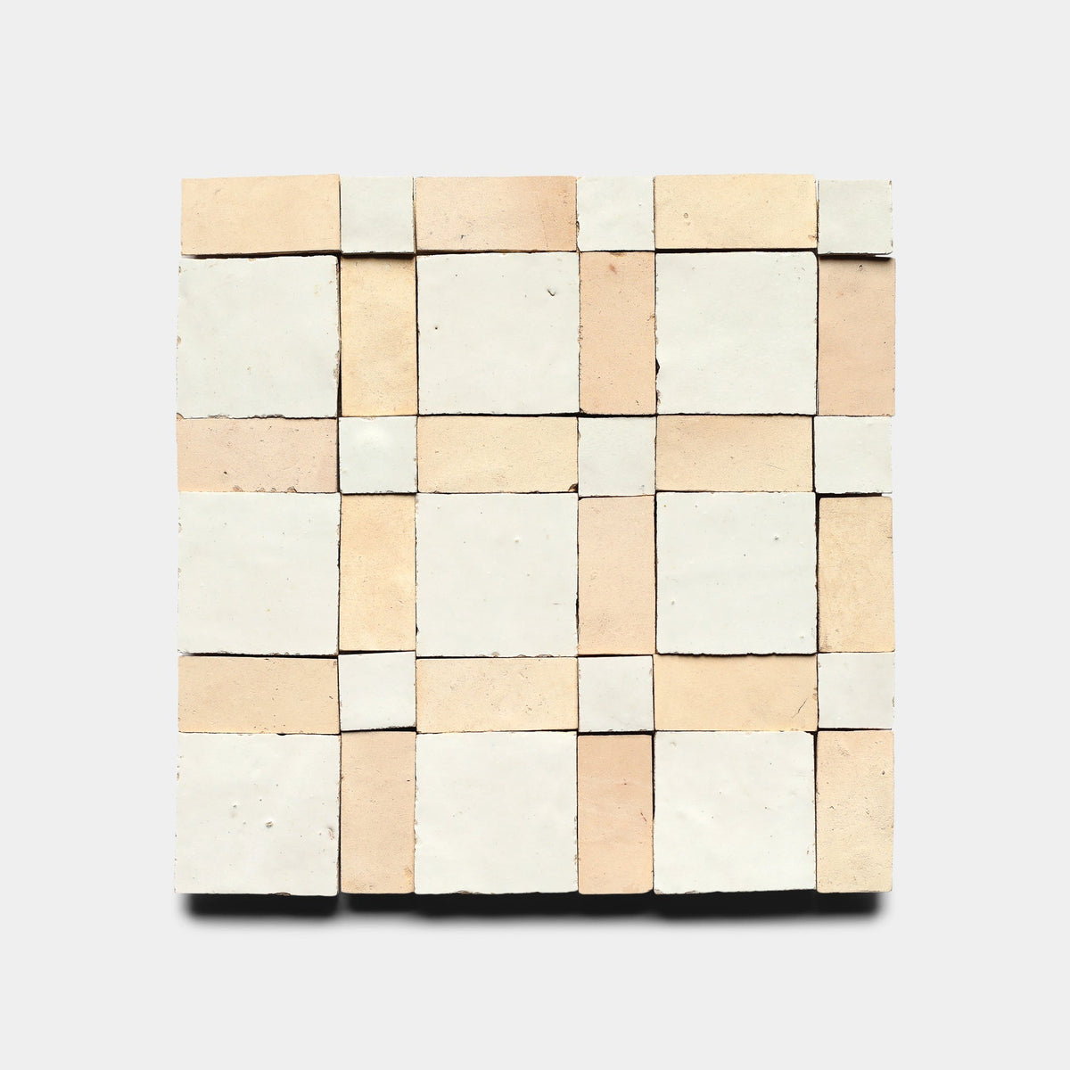 Gambit 2, Sample by Zia Tile features a handcrafted square mosaic in a symmetrical checkerboard of cream and light beige, highlighting artisanal elegance against a plain background.
