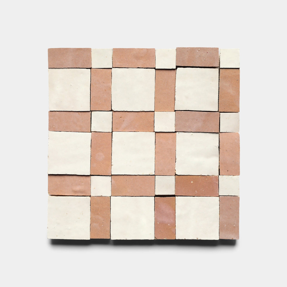 The Gambit 3, Sample by Zia Tile is a handmade square tile with a checkered pattern of alternating light beige and terracotta squares, creating a geometric grid design on a plain white background.