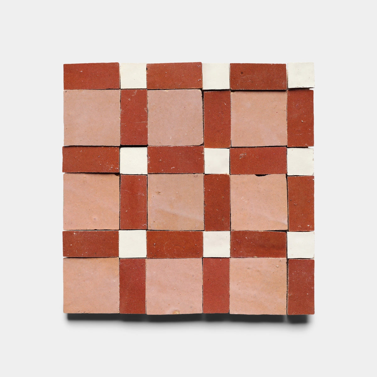 The Gambit 4 sample by Zia Tile features a handmade checkerboard pattern with alternating red, light pink, and small white squares on a light background, inspired by classic Zia Tile design.