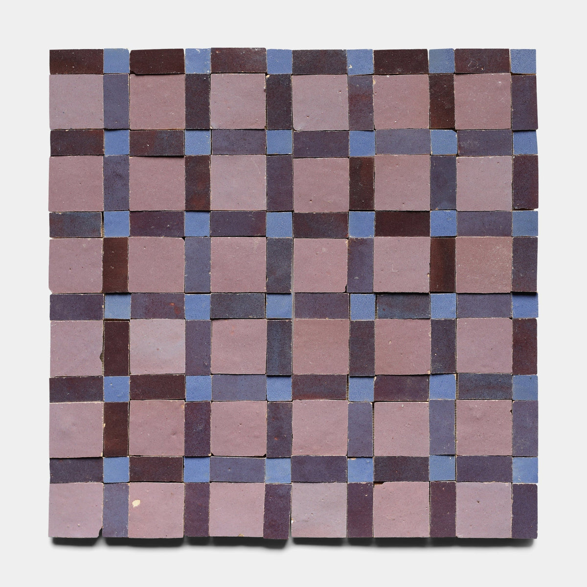 Gambit 8 by Zia Tile features square tiles in a checkerboard pattern with alternating dark purple and muted blue handcrafted tiles on a light background.