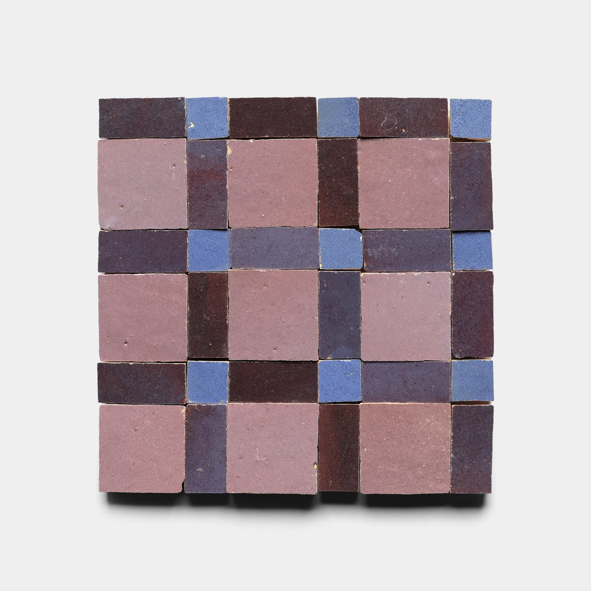 Gambit 8, Sample by Zia Tile features handcrafted square tiles in mauve, burgundy, and blue set in a checkerboard and grid pattern on a white background.