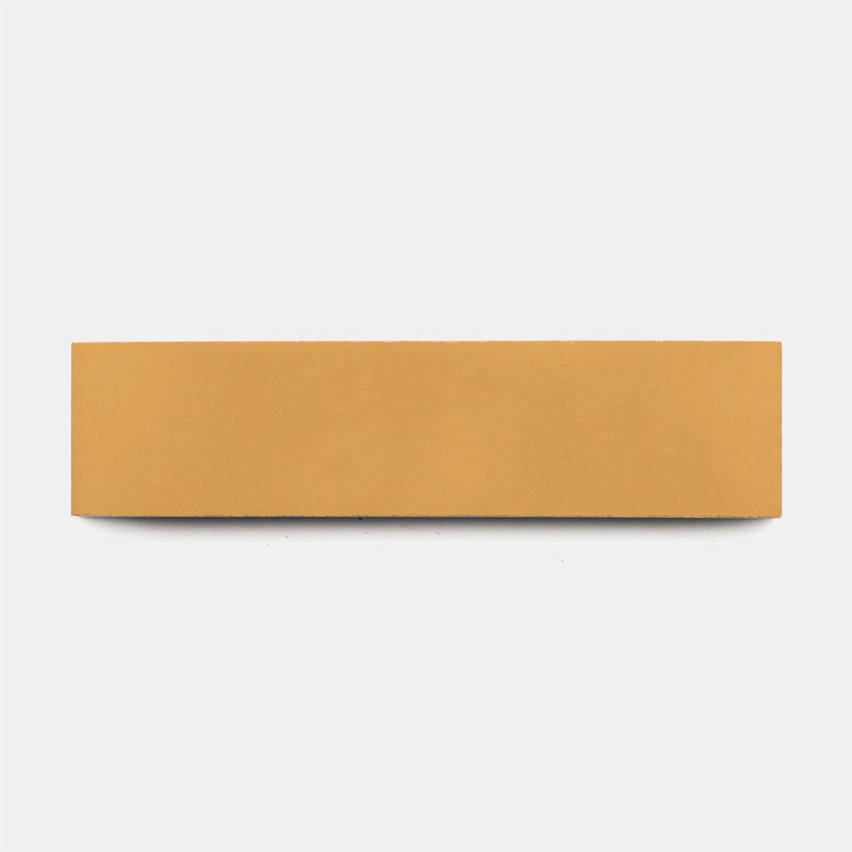 A rectangular, flat, light brown object resembling a wooden or cork block is centered on a plain white background, similar to the Ginger 2x8, Sample by vendor-unknown.