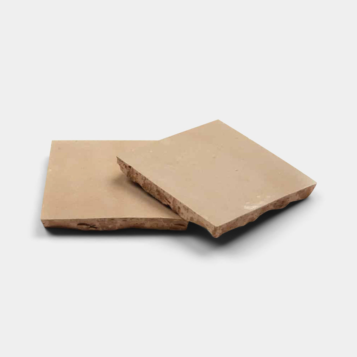 Two pieces of Glazed Earth 2x2 tile samples by Zia Tile, one angled atop the other like handcrafted tiles, with smooth tops and rough, uneven edges against a plain white background.