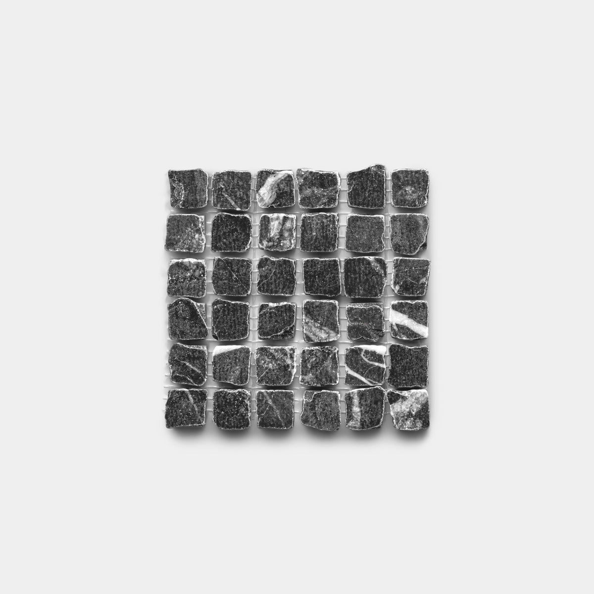 A square grid of Ventaglio in Grigio Carnico, Sample by Zia Tile, showcases glossy, uneven black stone tiles on a white background, each featuring unique textures and natural edges.