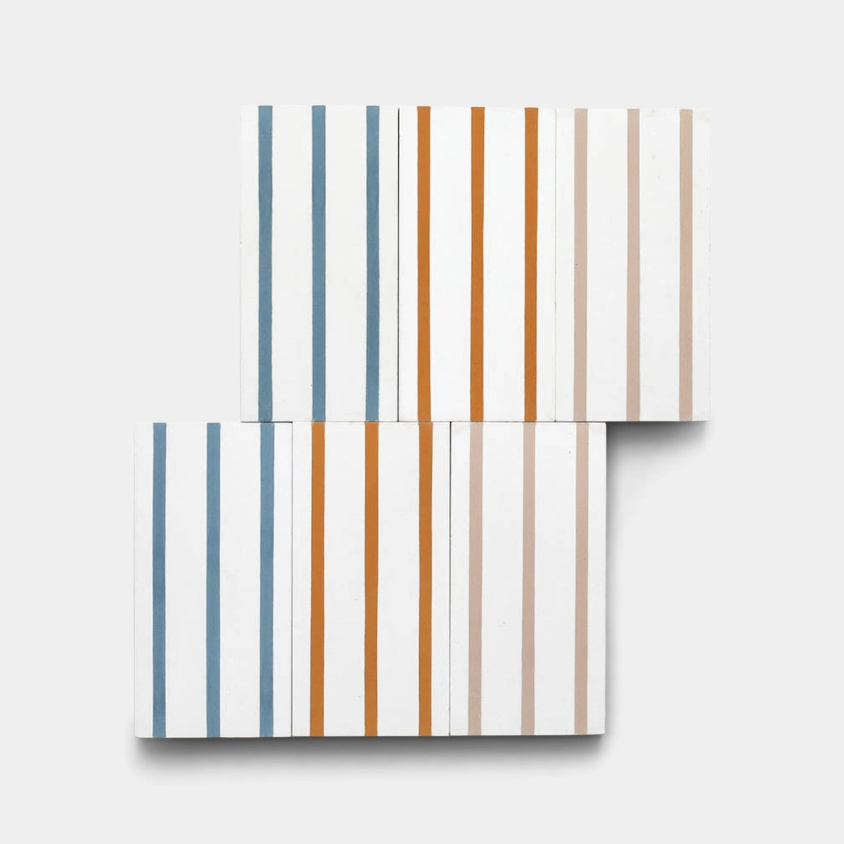 Four white High Line Hyannis 4x8 tiles from Zia Tile are arranged in an offset grid, each featuring three vertical blue, orange, or beige stripes for a minimalist geometric look on a light gray background.