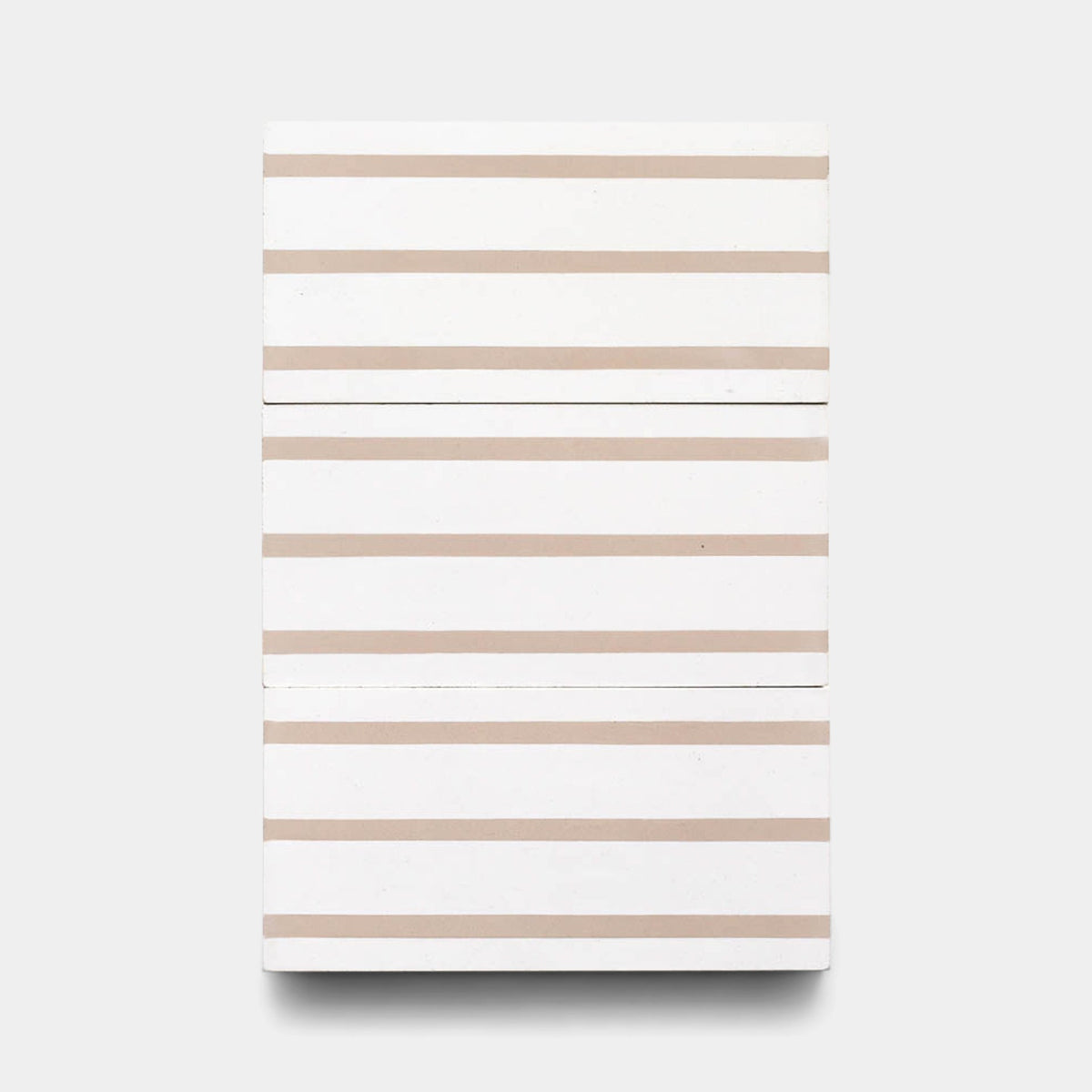 The High Line Jaipur Pink 4x8 sample by Zia Tile is a rectangular, handmade tile featuring evenly spaced, horizontal beige stripes for a minimalist geometric look against a white background.