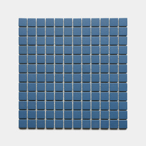 The Iconic Blue 1x1 tiles from Zia Tile form a uniform, geometric square grid of small, evenly spaced blue tiles set against a light gray background.