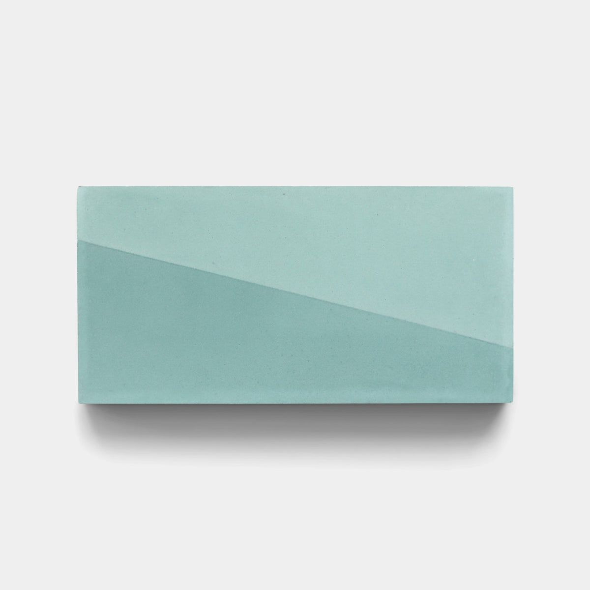 The Incline Salvia 4x8 Sample by Zia Tile is a rectangular, light blue-green handmade ceramic tile with a subtle diagonal gradient, shown on a plain white background.