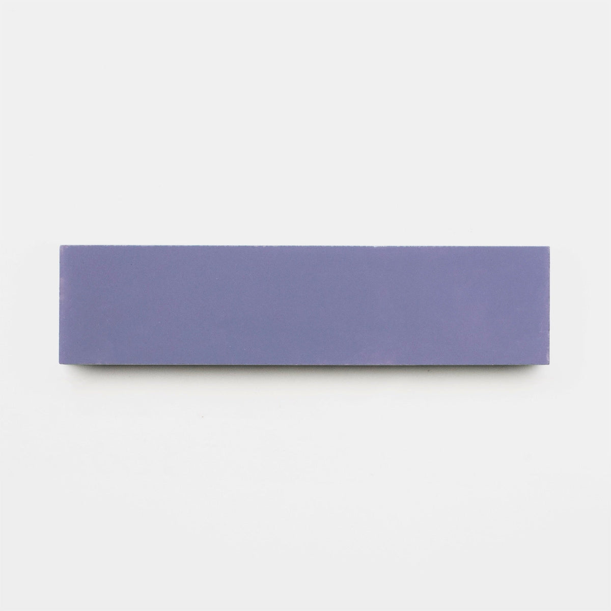 A rectangular, solid indigo eraser sample from vendor-unknown’s Indigo 2x8 collection is displayed horizontally on a plain white background, evoking the clean lines of handmade tile design.