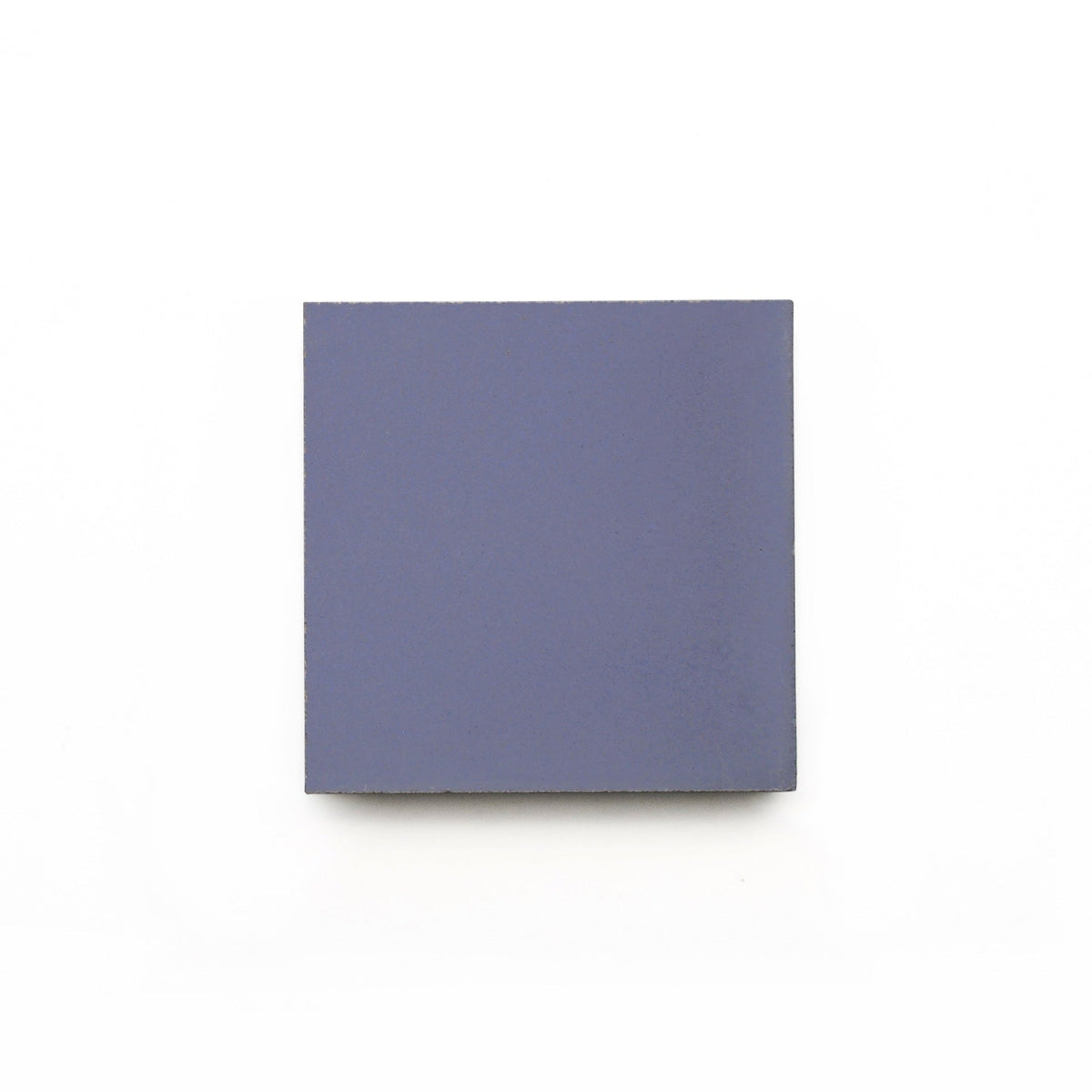 A single, solid Indigo 4x4 handmade tile sample by vendor-unknown, square-shaped and muted blue, centered on a plain white background.