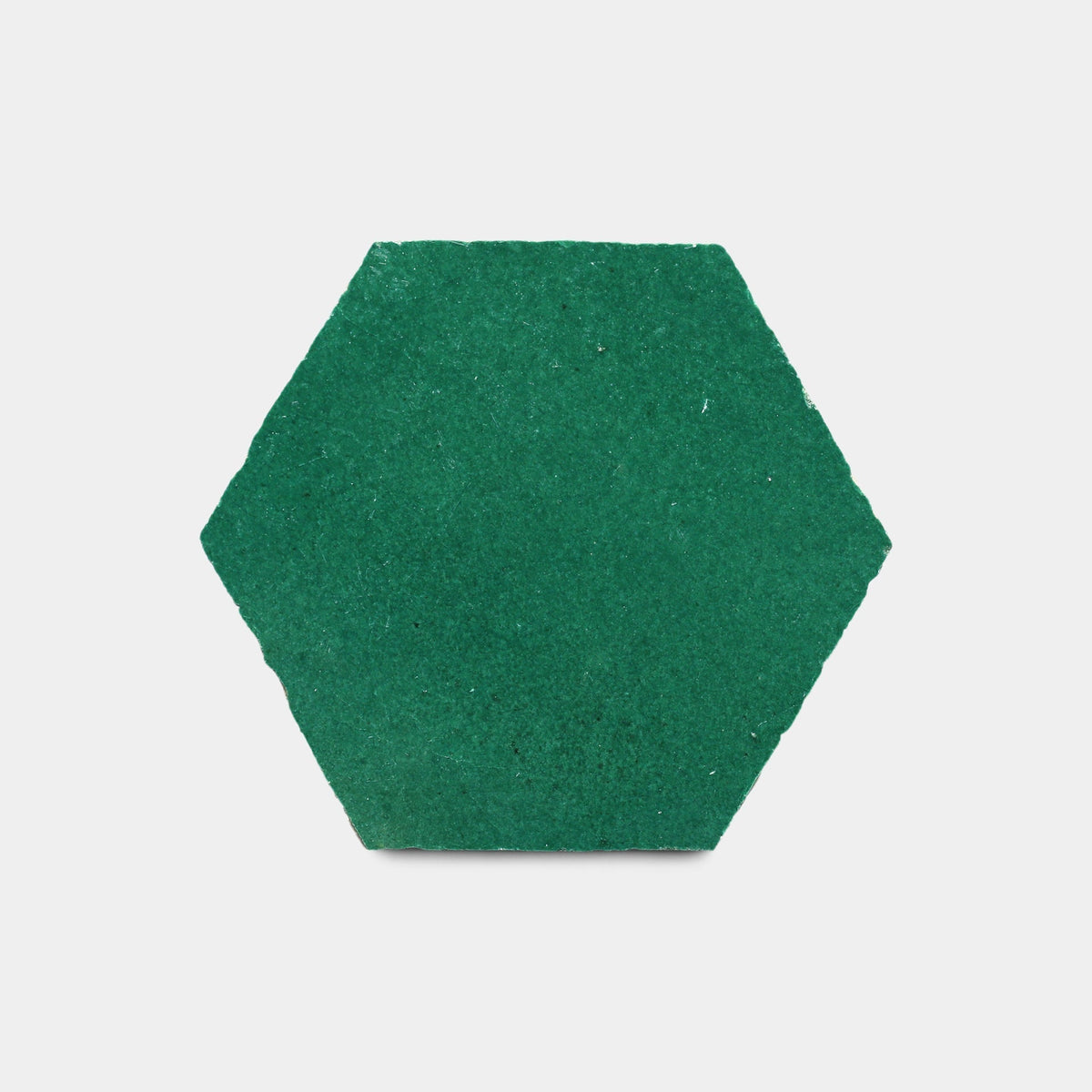 The Jade Hex Sample by Zia Tile, a green ceramic tile with a textured hexagon shape, is centered on a plain white background.