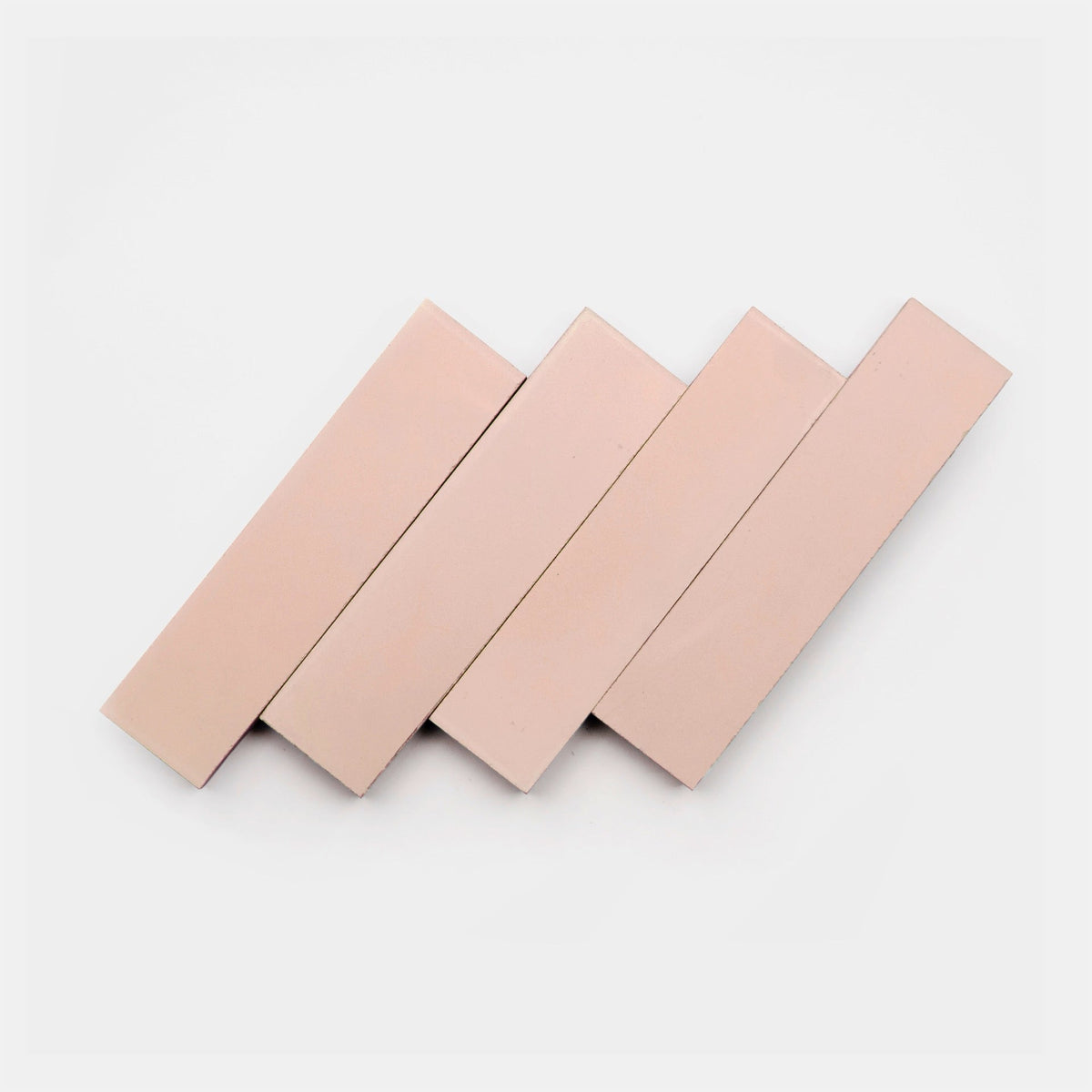Four Jaipur Pink 2x8 tiles by vendor-unknown are arranged diagonally in a staggered, overlapping pattern on a white background.