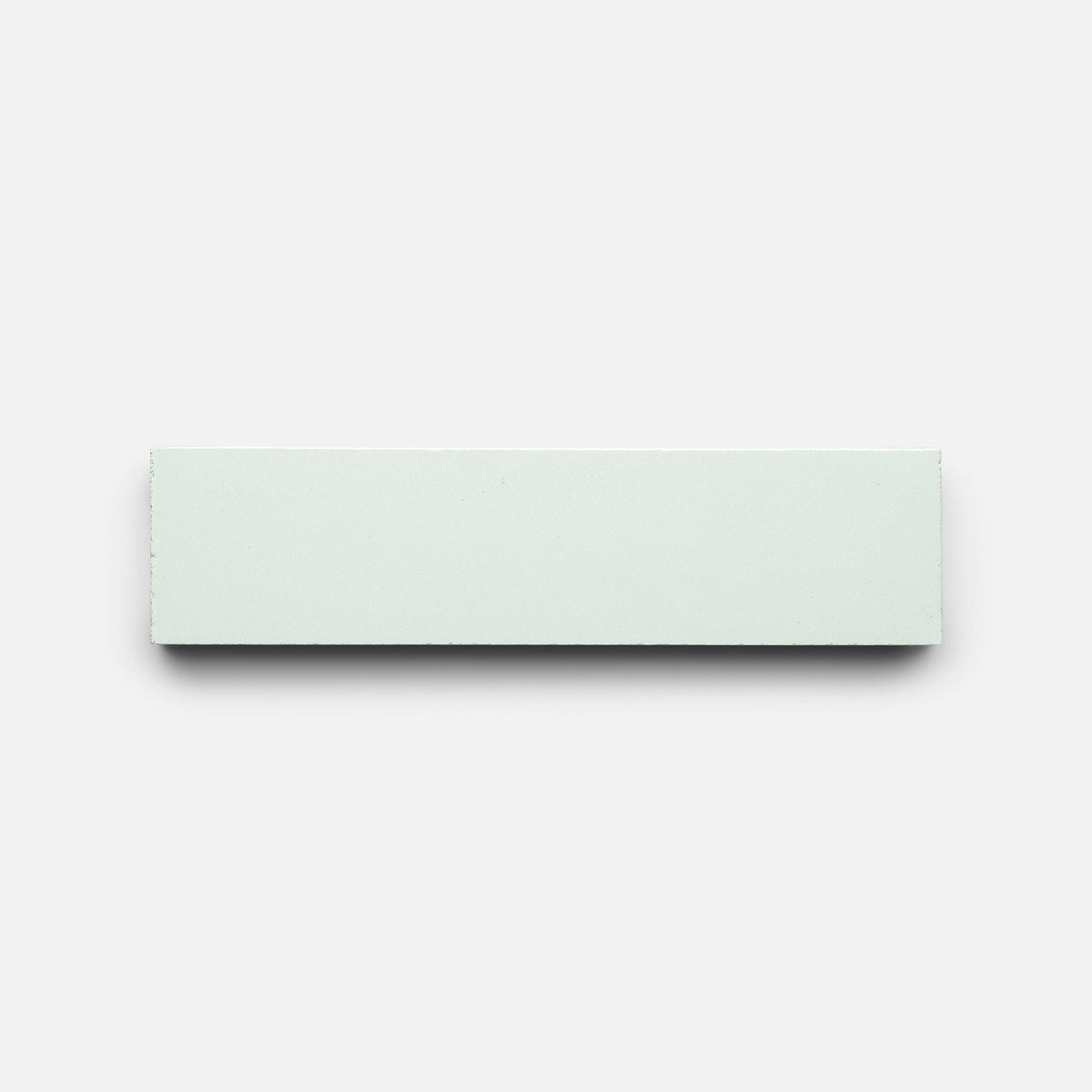 The Julep 2x8 Sample by Zia Tile, a plain rectangular white tile, is centered on a light gray background.