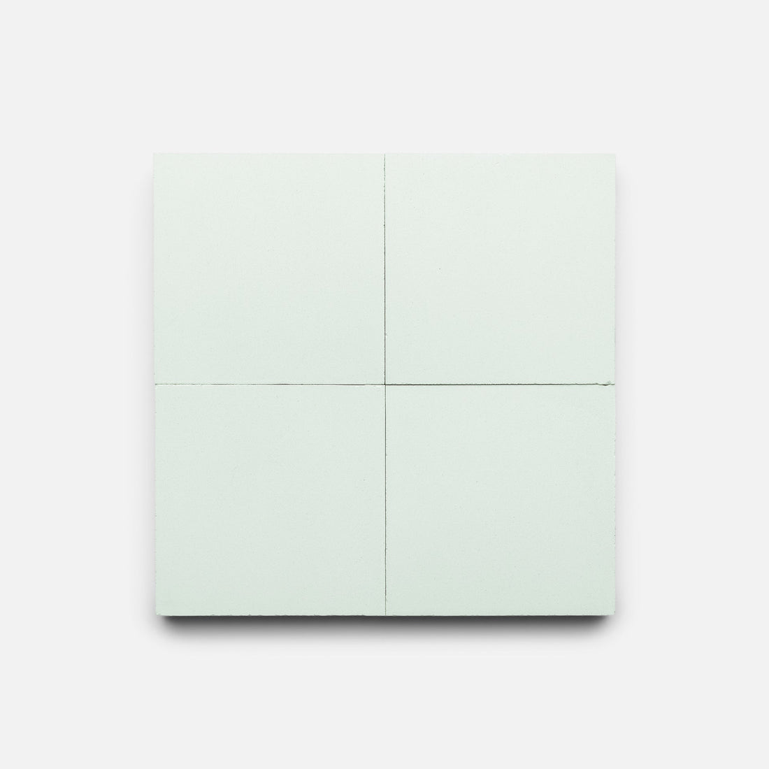 The Julep 4x4 by Zia Tile is a square, pale mint green chocolate bar divided into four equal sections, resembling a handmade tile and displayed on a plain white background.