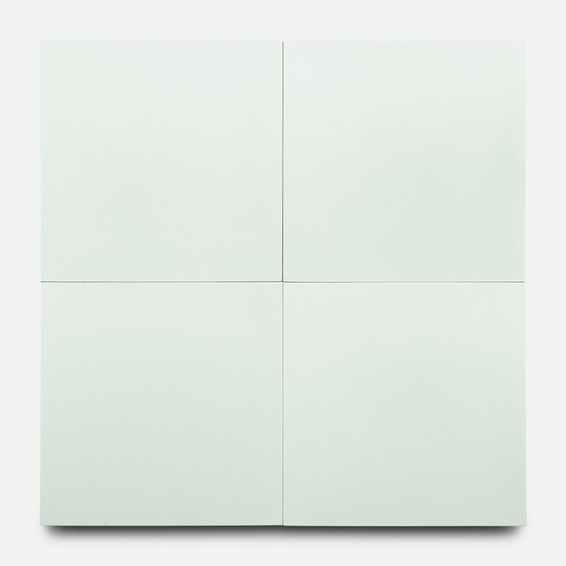 Zia Tile’s Julep 8x8 features four minimalist, pale off-white square panels arranged in a grid, reminiscent of handmade tile. The panels are separated by thin gaps on a plain white background for a subtle, modern look.
