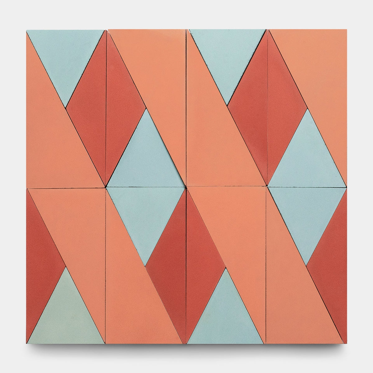 The Kepler Set One, Sample by Zia Tile features geometric wall art inspired by handmade tiles, with a grid of rectangles and diamond shapes in coral, light blue, and red for a modern, abstract look.