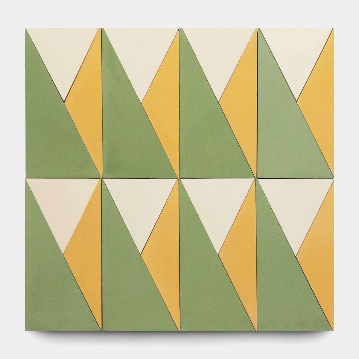 The Kepler Set Two, Sample by Zia Tile features ten cement tiles with geometric patterns in green, yellow, and off-white triangles, creating a repeating abstract design on a plain background.