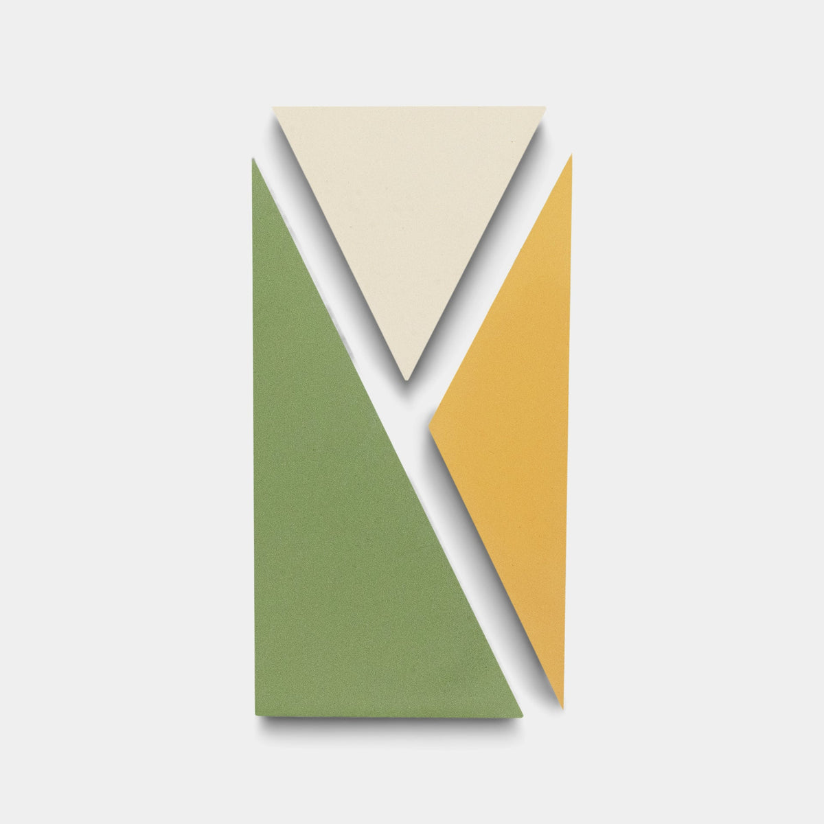 The Kepler Set Two sample by Zia Tile features a handmade-style design with a green right triangle, cream inverted triangle, and yellow parallelogram forming a rectangle on a white background.