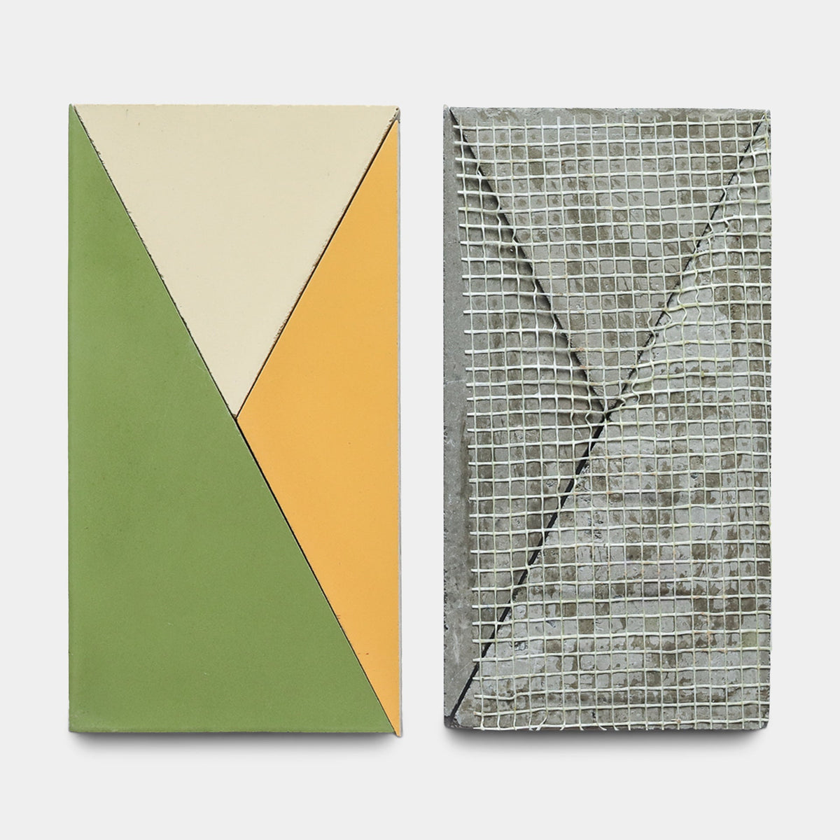 Two rectangular tiles from Zia Tile's Kepler Set Two, Sample: the left showcases green, yellow, and cream handmade geometric designs; the right displays gray concrete cement with a mesh grid and diagonal indentation.
