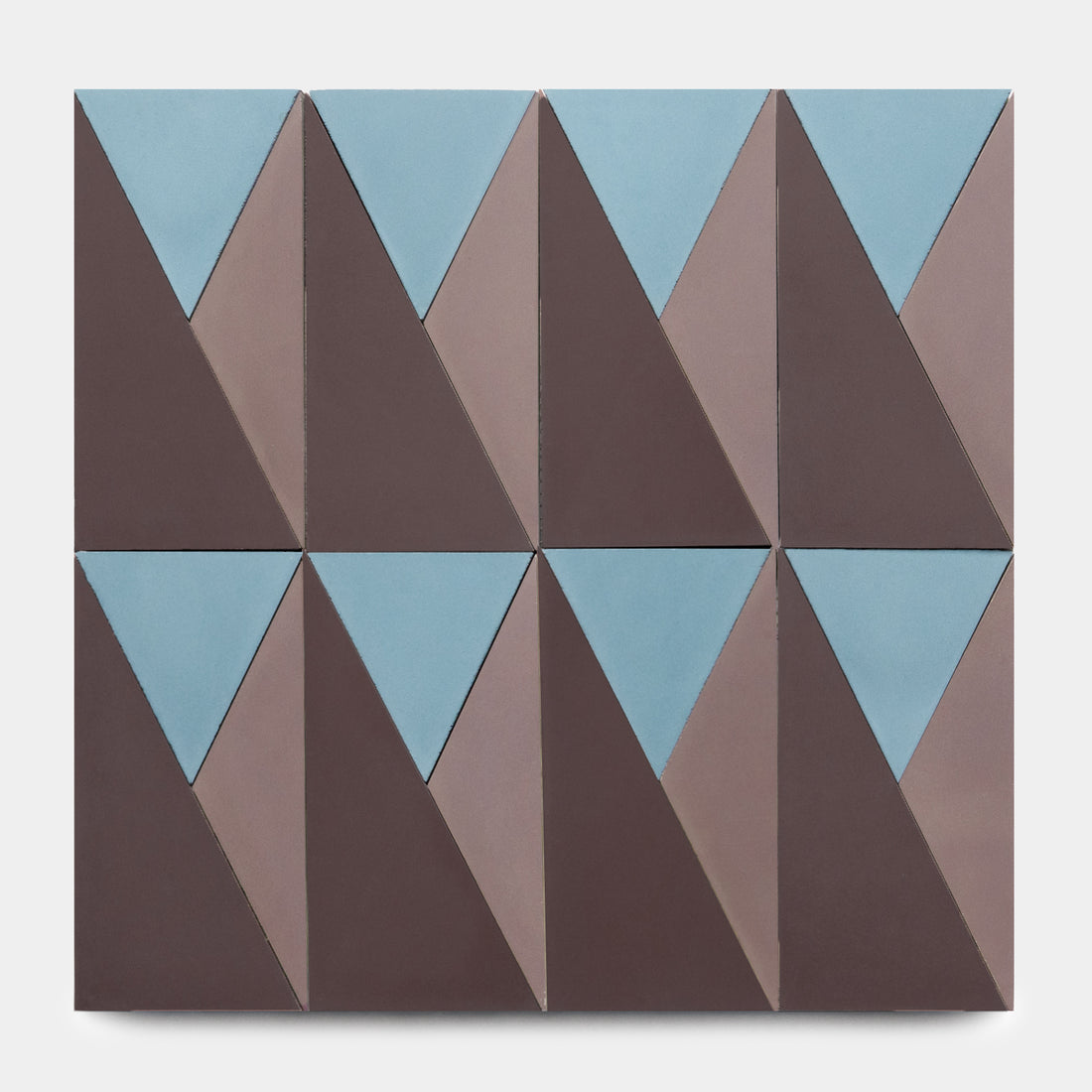 The Kepler Set Three by Zia Tile features geometric wall art with eight rectangles showcasing interlocking blue and brown triangles in a repeating abstract pattern inspired by classic Zia Tile ceramic designs on a white background.