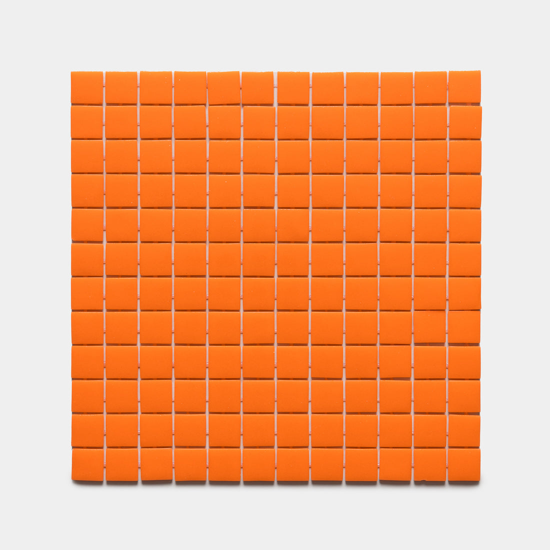 A grid of 100 Kumquat 1x1 tiles by Zia Tile is arranged in a 10 by 10 square on a white background.