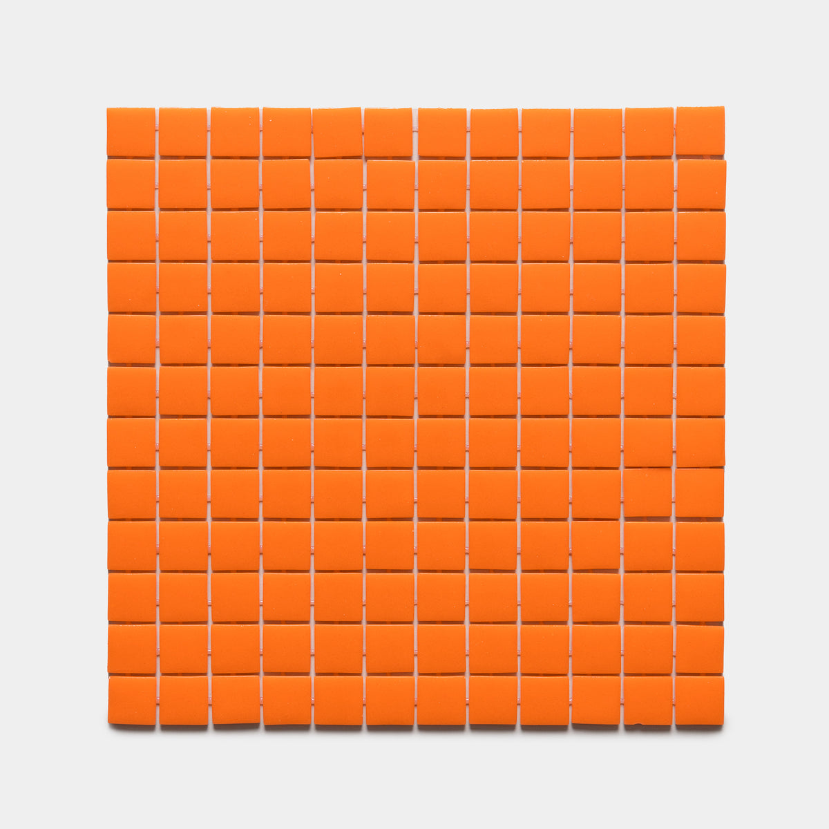 A grid of 100 Kumquat 1x1 tiles by Zia Tile is arranged in a 10 by 10 square on a white background.