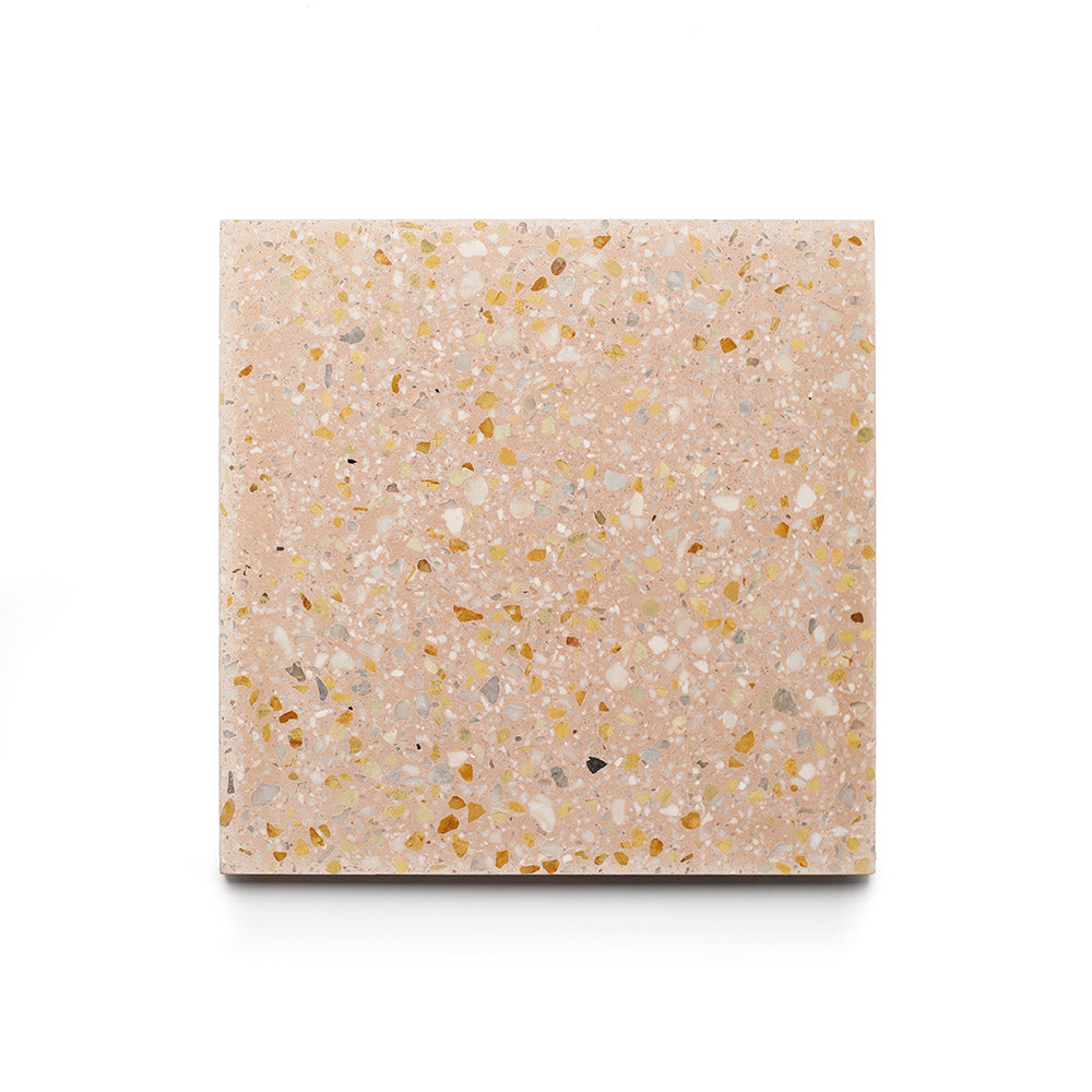 The Las Palmas 6x6 Sample by Zia Tile is a handmade square terrazzo cement tile featuring a light pink base with yellow, white, and brown chips, shown against a plain white background.