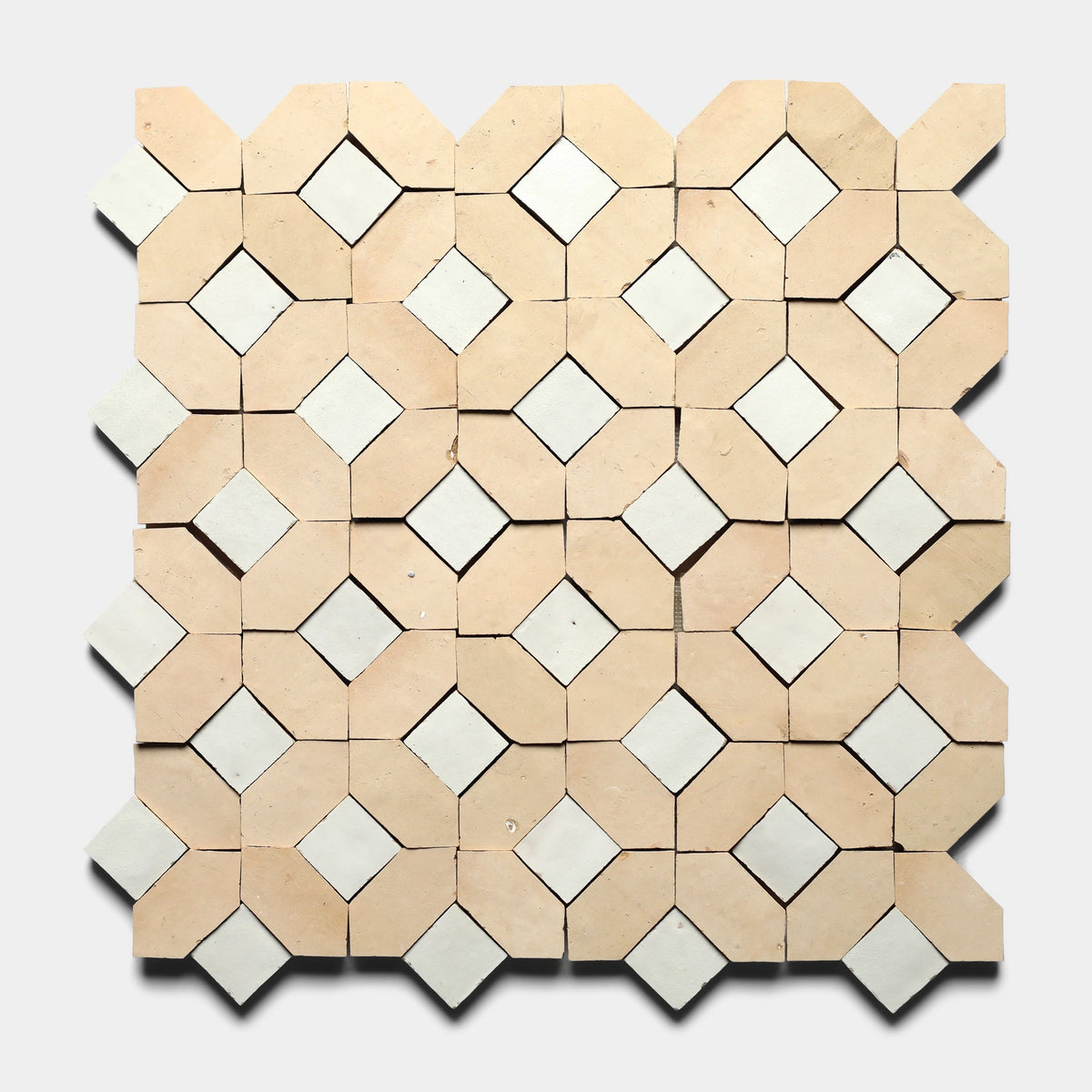 Experience the artisanal craftsmanship of Zia Tile with Lattice 1, Sample—beige octagonal cement tiles and white diamond-shaped tiles form a symmetrical geometric pattern on a light gray background.