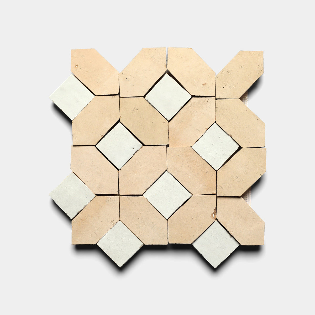 The Lattice 1, Sample by Zia Tile features a geometric pattern of beige octagons and white diamonds on cement tiles, arranged in a square against a light gray background.